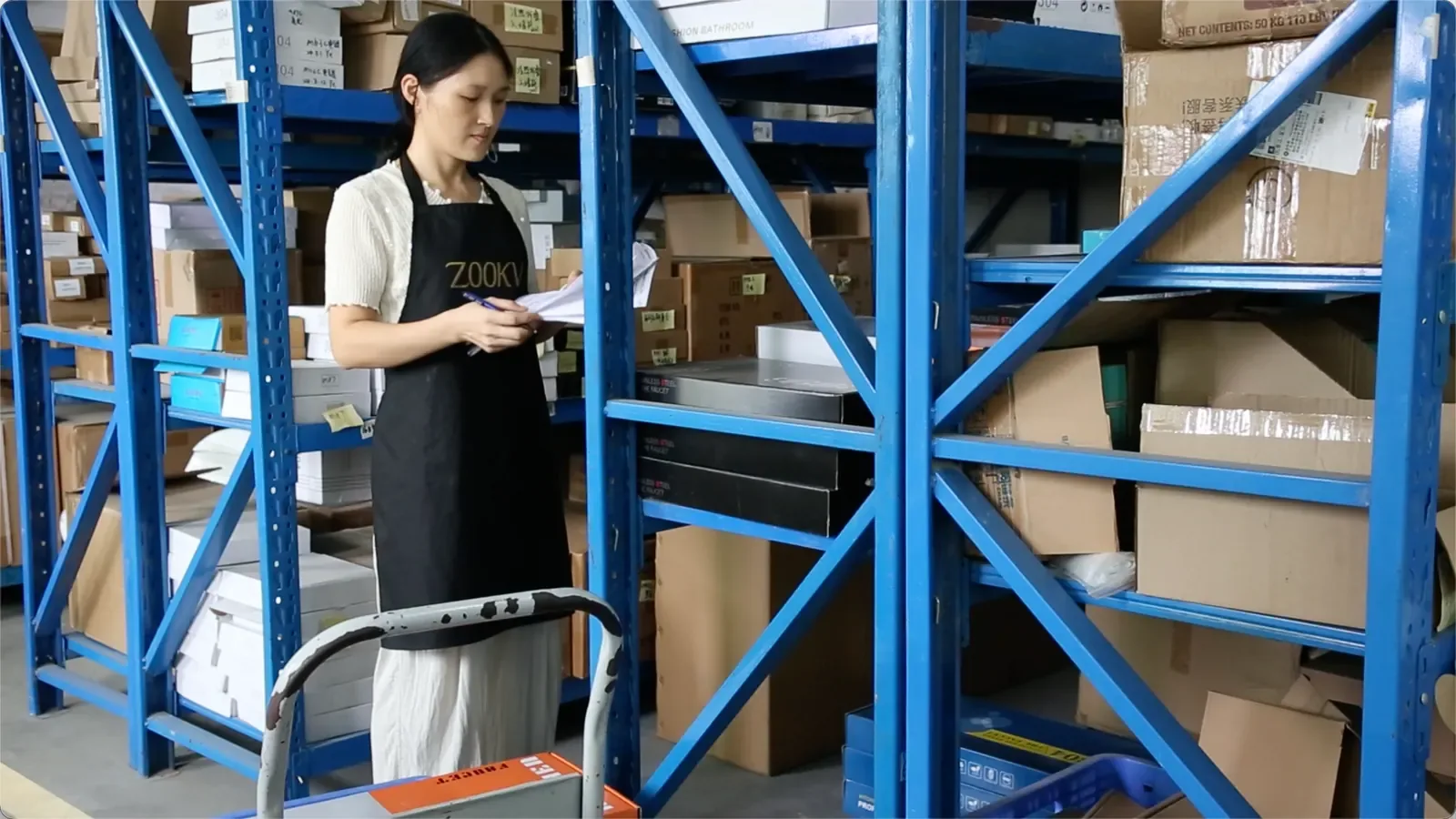 ZOOKV staff checking stock against paperwork in the warehouse